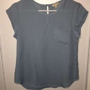 Short sleeved mauve tone blue shirt .